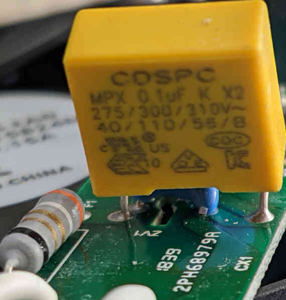 The X2 input filtering capacitor (yellow), and the fuse (F1).