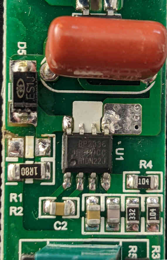The <a href='/assets/files/2020-02-08-grow-light-teardown/BP2338J.pdf'>Bright Power Semiconductor Co. BP2338J</a> constant-current LED driver. Pins 6 & 7 are not connected--it's unclear why this was done, but pins 8 & 7 and 5 & 6 are connected internally to the chip. You can also observe the current measurement: R2=1.8Ω, Vref=0.2V, and therefore the output current is Vref/R2=111mA. This matches the observed output current.
