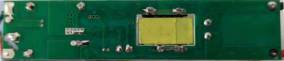 The bottom side of the power supply. Note that two transformer pins are tied together: it is being used as an non-isolated inductor, and was likely chosen over a regular inductor for cost reasons.